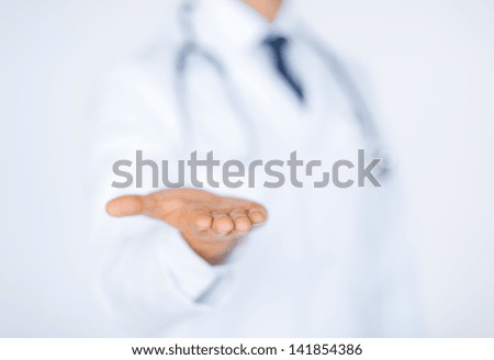 close up of male doctor holding something in his hand