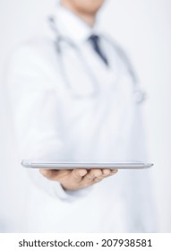 Close Up Of Male Doctor Holding Tablet Pc