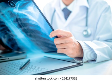 close up of male doctor holding x-ray or roentgen image - Shutterstock ID 254197582