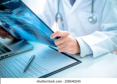 close up of male doctor holding x-ray or roentgen image - Shutterstock ID 258540245