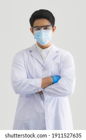 Close Up Male Doctor, Researcher, Scientist Wearing Eye Protection Glasses With A Suit And Mask On White Background. Healthcare And Medical Concept.