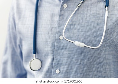 close up of male doctor with a stethoscope on shoulder on grey background. Healthcare and Medical concept. - Shutterstock ID 1717001668