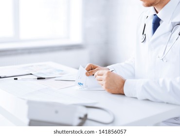 Close Up Of Male Doctor Writing Prescription Paper