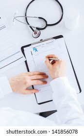 Close Up Of Male Doctor Writing Prescription Paper