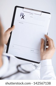 Close Up Of Male Doctor Writing Prescription Paper