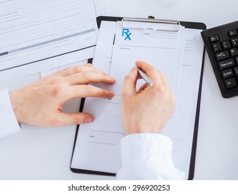 Close Up Of Male Doctor Writing Prescription Paper