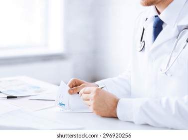 Close Up Of Male Doctor Writing Prescription Paper