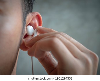 Close Up Male Ear With Earphone Inside.Headphone Concept.