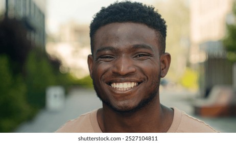 Close up male face happiness expression portrait African American happy smiling guy in city laugh funny reaction enjoy biracial man smile toothy white teeth dental service dentistry medicine outdoors - Powered by Shutterstock