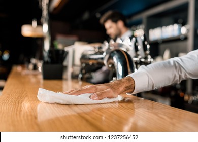 Close Up Of Male Hand Cleaning Wooden Bar Counter