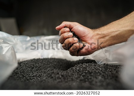Close up of male hand holding plastic polymer granules [[stock_photo]] © 