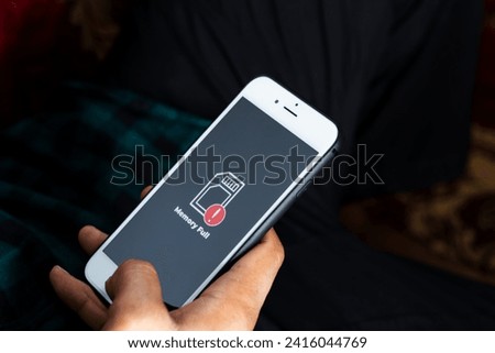 Close up of male hand holding a smart phone with sign full storage icon on screen. Communication, cellular problem, bad connection concept.