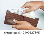 Close up male hand open the wallet.He has lot money us dollar in wallet. Financial business concept.