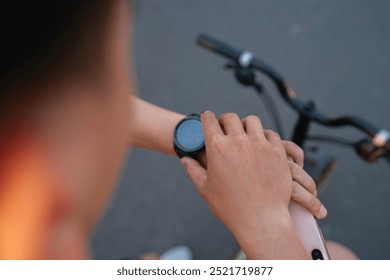 close up male hand riding bicycle checking smartwatch - Powered by Shutterstock