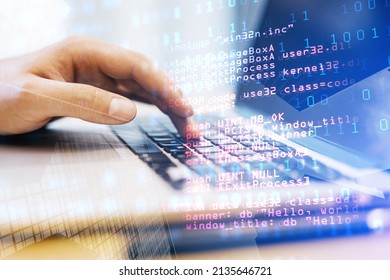 Close up of male hand using laptop keyboard with abstract html code on creative city background. Coding and programming concept. Double exposure