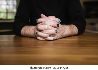 Close Up Of Male Hands Clasped With Nail Polish