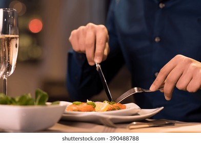 Close up of a male hands cutting and eating delicious salad with knife and fork at restaurant. Man enjoying meal at a restaurant. Close up of a plate of salmon fillet at luxury restaurant.
 - Powered by Shutterstock