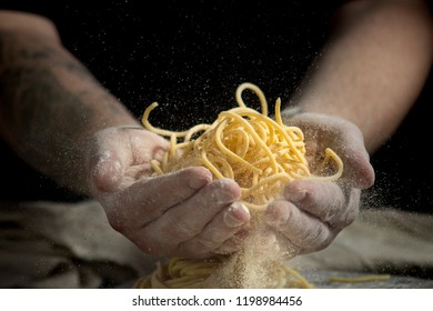 close up of male hands holding freshly made pasta. Homemade spaghetti