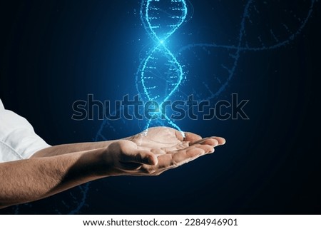 Close up of male hands holding glowing DNA helix hologram on dark background. Medicine and bioengineering concept