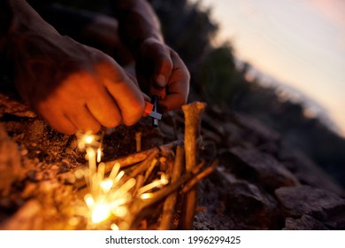 Close up of male hands making a fire with flint and steel in the wild. Outdoor adventure, tourism concept - Powered by Shutterstock