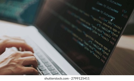 Close up of male hands typing programming on screen laptop Camera slides around