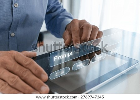 Close up of male hands using a digital tablet at a desk, interacting with a futuristic holographic overlay featuring an artificial intelligence prompt bar with chat, video, and image genration options.