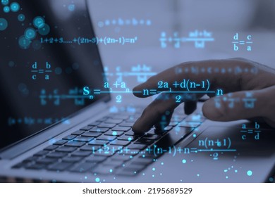 Close up of male hands using laptop keyboard at workplace with monitor, supplies and glowing mathematical formulas on blue background. Education, knowledge and statistics concept - Powered by Shutterstock - Get 15% off with code: PIKWIZARD15