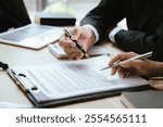 Close up of male lawyer working with contract documents and wooden hammer on table in courtroom. Justice and law. Judge in suit or lawyer working with documents. Law. Close up.