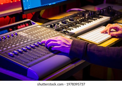 Close Up Male Sound Engineer Hand Mixing Music On Digital Audio Mixing Board In Sound Studio. Music Production Concept