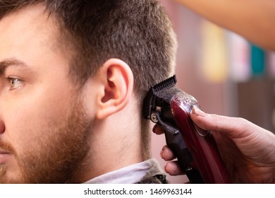 Close Up Of A Male Student Having A Haircut With Hair Clippers
