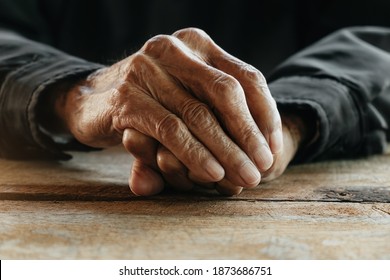 Close up of male wrinkled hands, old man is wearing