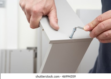 Close Up Of Man Assembling Flat Pack Furniture