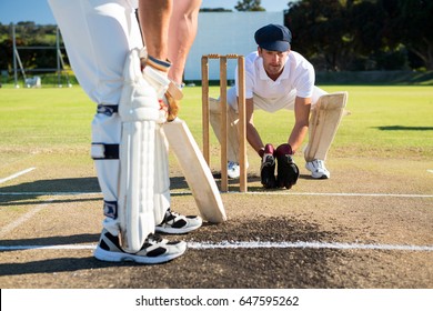 Close Up Of Man Batting While Playying Cricket At Field On Sunny Day