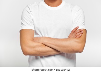 Close Up Of Man In Blank T-shirt With Folded Arms