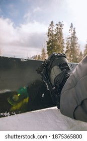 Close Up Man Boots Strap In Snowboard