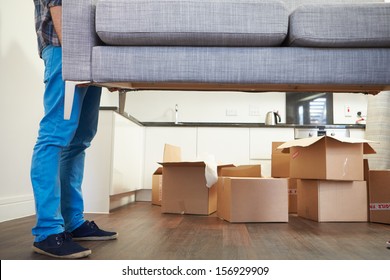 Close Up Of Man Carrying Sofa As He Moves Into New Home - Shutterstock ID 156929909