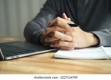 Close up of man clasped hands clenched together on table, businessman preparing for job interview, concentrating before important negotiations, thinking or making decision, business concept - Shutterstock ID 2227114709