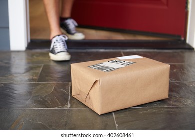 Close Up Of Man Collecting Parcel Delivery Outside Door