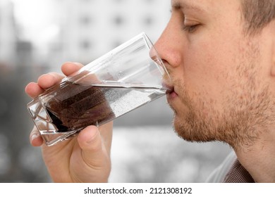 Close Up Man Is Drinking Dirty Water. Water Pollution Concept