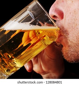 Close Up Of A Man Drinking A Glass Of Beer