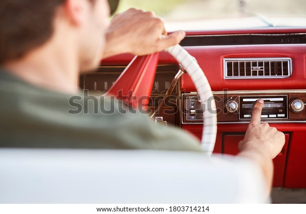 Close up of man driving an old car                      \
        