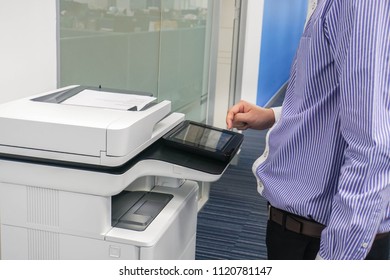 Close up man employee work with multifunction printer to scan and copy business documents in office