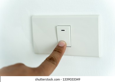 Close Up Of Man Finger Is Turning On Or Off On Light Switch