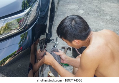 Close Up Man Fix And Maintenance Disc Brake Of The Favourite Car In Holidays