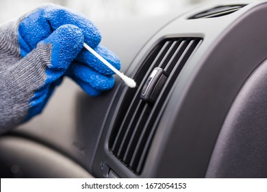 Close Up Of Man Hand Cleaning Car Air Conditioning Vent Grill With Cotton Swab.