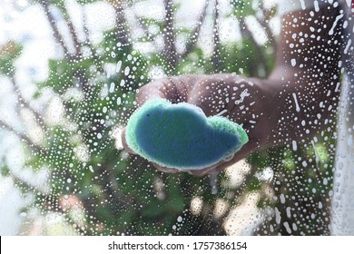 Close Up Of Man Hand Cleaning Window Glass 