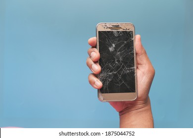 Close Up Of Man Hand Holding Broken Smart Phone.