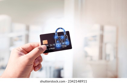 Close up of man hand holding credit or debit card with padlock, protection of financial transactions, copy space, Financial security technology concept. - Powered by Shutterstock