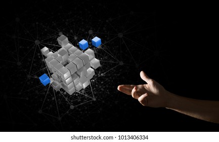 Close of man hand holding cube figure as symbol of innovation. Mixed media.