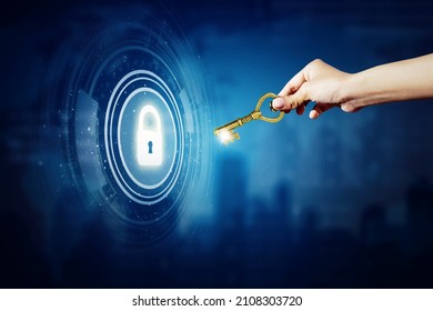 Close up of man hand holding a golden key to open a virtual padlock in the cyberspace